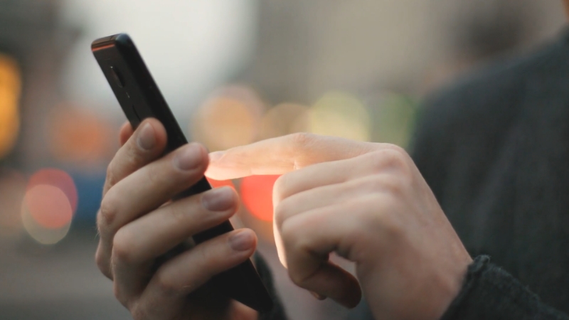 A person is checking their smartphone screen while ensuring they are connected to a secure network
