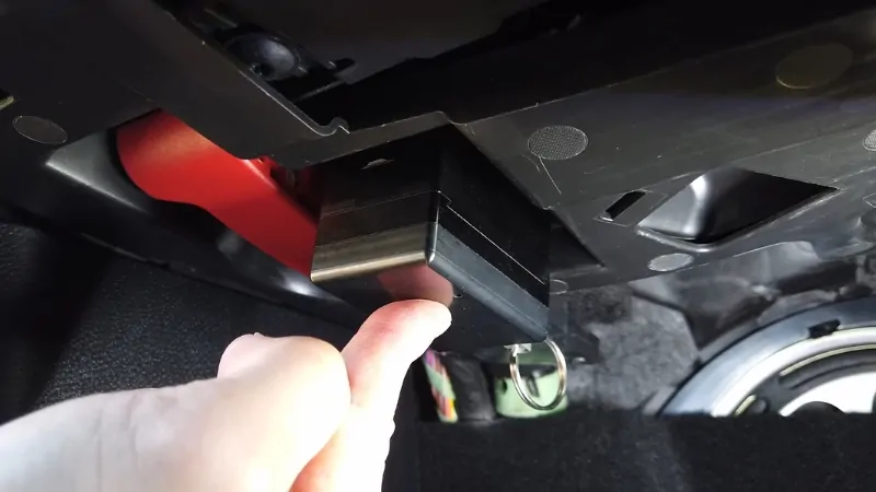 A Close-Up of A Hand Interacting with An Electronic Device or Component Inside a Vehicle