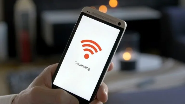 A person is holding a smartphone showing the "Connecting" screen to a Wi-Fi network, with a focus on how to protect your data