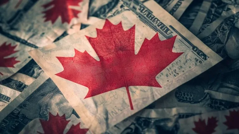 Canadian maple leaf overlay on U.S. currency, symbolizing Canadian tax regulations and income