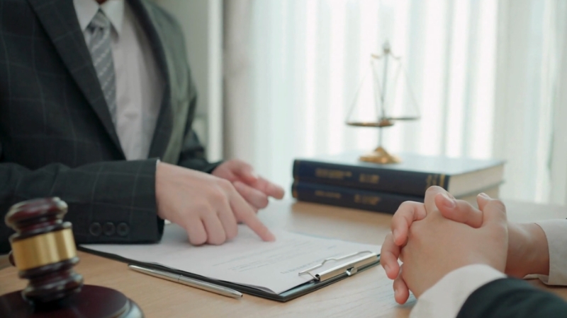 A lawyer advising a client on legal defense and immigration strategy