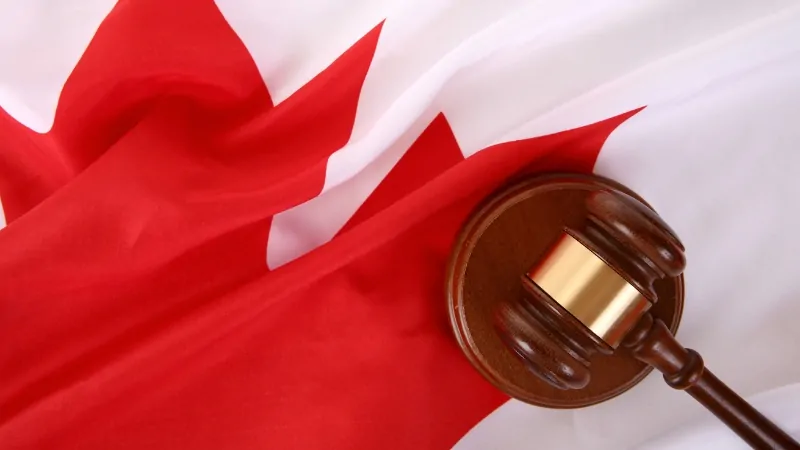 A judge’s gavel rests on a Canadian flag, symbolizing laws against pirate streaming sites in Canada