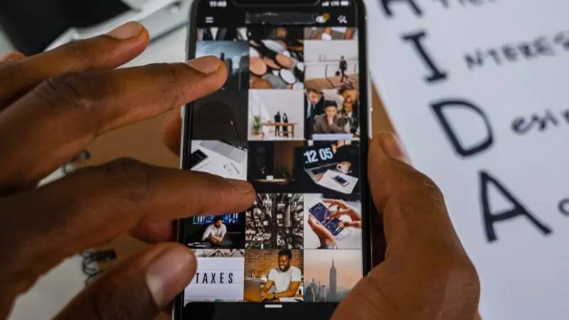 A person browses social media content on a smartphone, reflecting trends in average daily social media usage