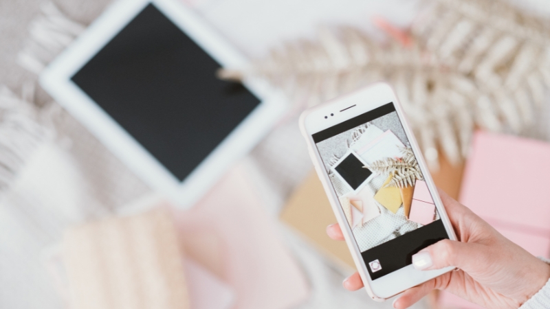 A person takes a photo with a smartphone, showing how users create and share content on social media