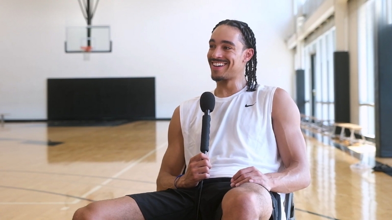 Andrew Nembhard smiles during an interview on a basketball court