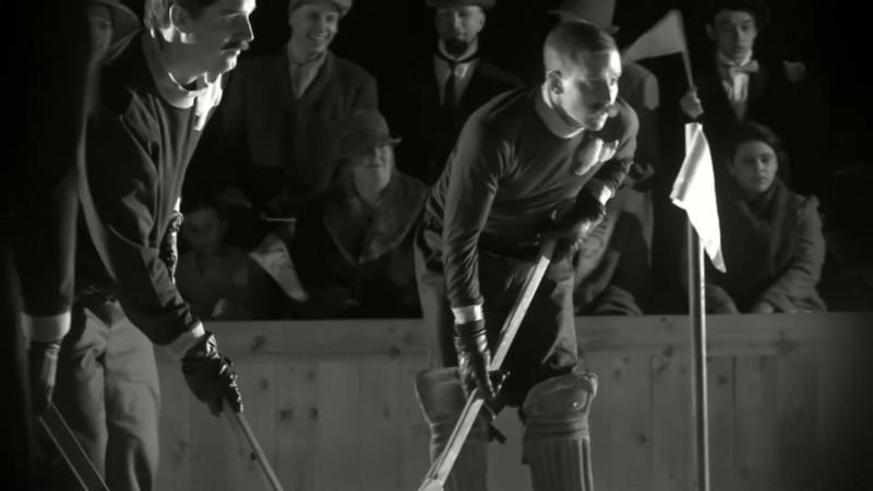 Vintage hockey players from the Winnipeg Victorias prepare for a faceoff during an early 1900s game